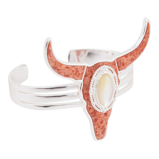Crescent-shaped ring with red stone and silver band on a white background