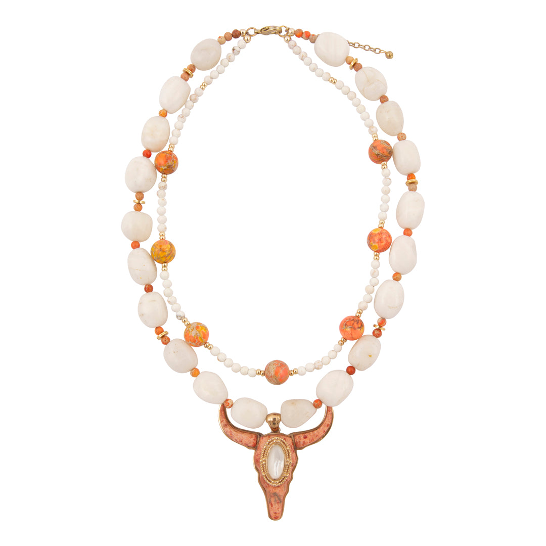 Necklace with white and orange beads and a decorative clasp on a white background