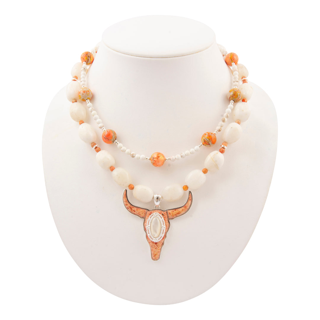 Necklace with longhorn bull head pendant on a white mannequin bust