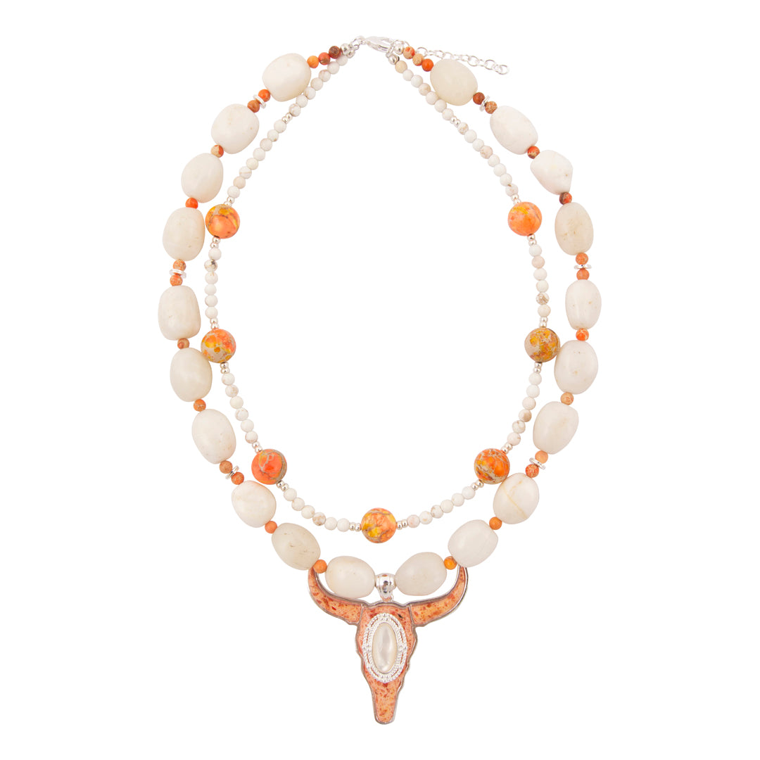 Necklace with white and orange beads and a decorative clasp on a white background