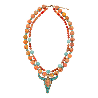 Multistrand beaded necklace with a prominent pendant on a white background