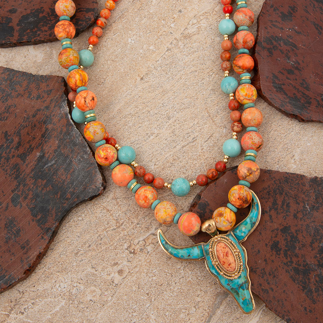 Necklace with colorful beads and a decorative clasp on a stone surface