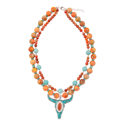 Multicolored beaded necklace with a turquoise pendant on a white background
