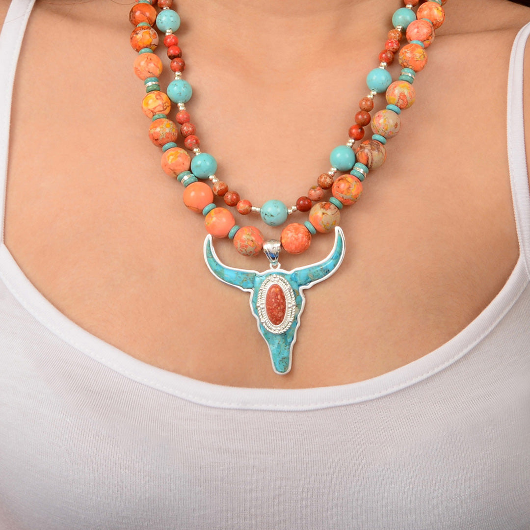 Necklace with a turquoise pendant worn by a person