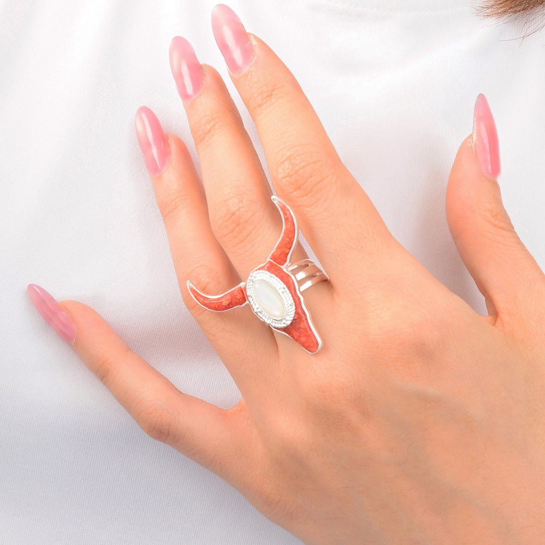 Hand wearing a ring with a clear design on a white background