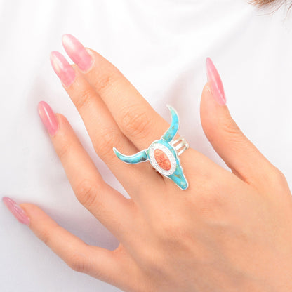 Hand wearing a turquoise ring with a pink nail design on a white background