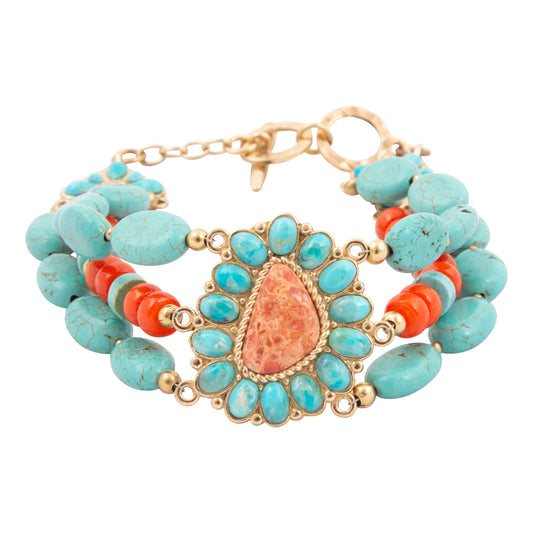 Turquoise and coral beaded bracelet with gold accents on a white background