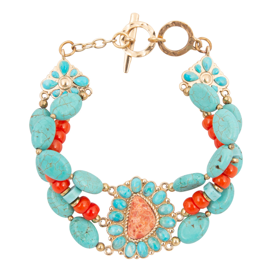 Turquoise and coral beaded bracelet with gold accents on a white background
