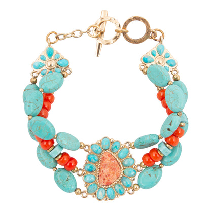 Turquoise and coral beaded bracelet with gold accents on a white background