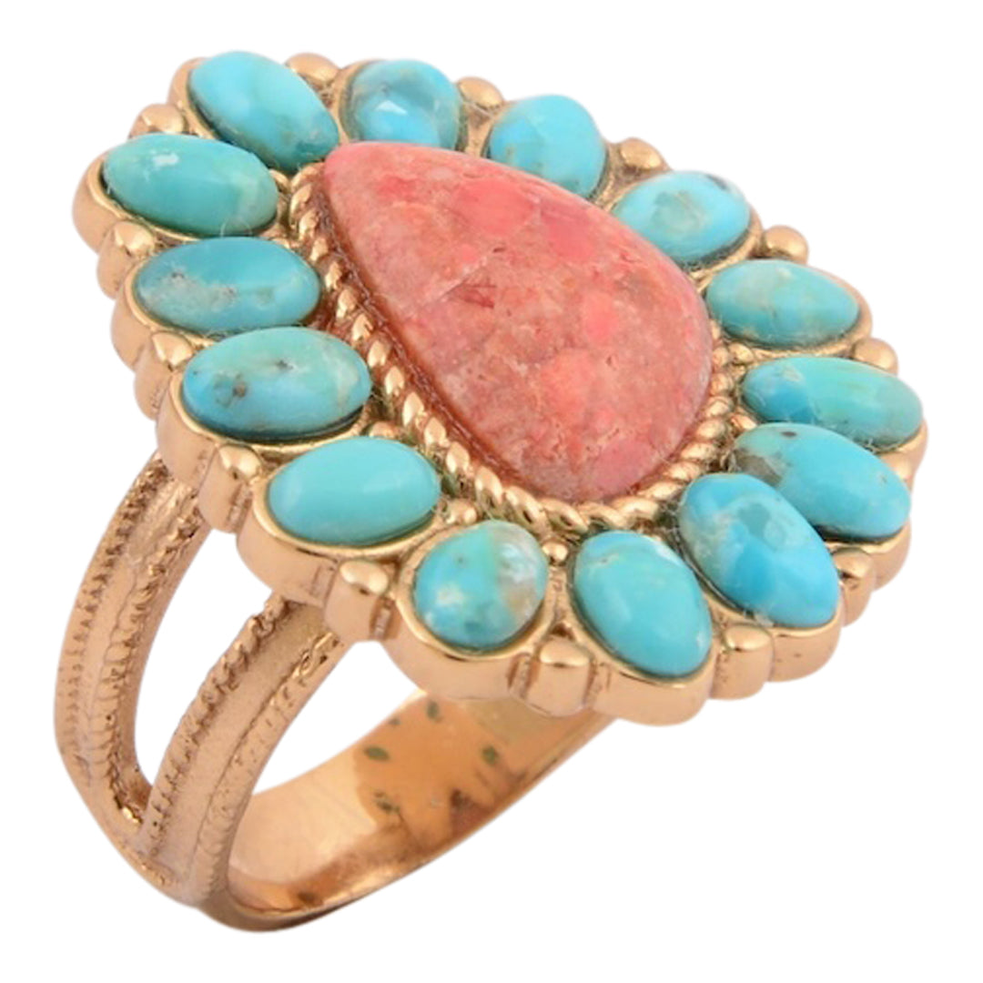 Ring with turquoise stones and a pink central stone on a white background