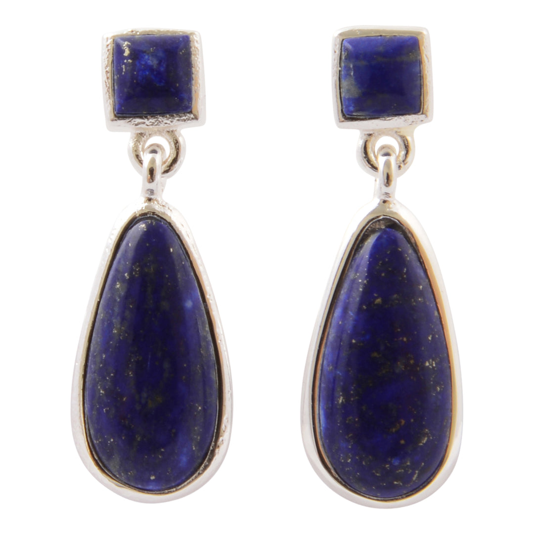 A pair of silver drop earrings featuring square-cut dark blue lapis lazuli stones at the top and larger teardrop-shaped lapis lazuli stones below, set in silver bezels on a white background.