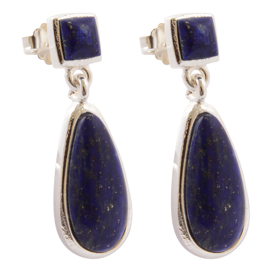 A pair of silver drop earrings featuring square lapis lazuli stones at the top and teardrop-shaped lapis lazuli stones below, set in polished silver bezels on a white background.