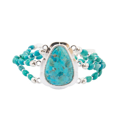 A turquoise beaded wrap bracelet with a large teardrop-shaped turquoise stone in a silver bezel setting, shown on a plain white background.