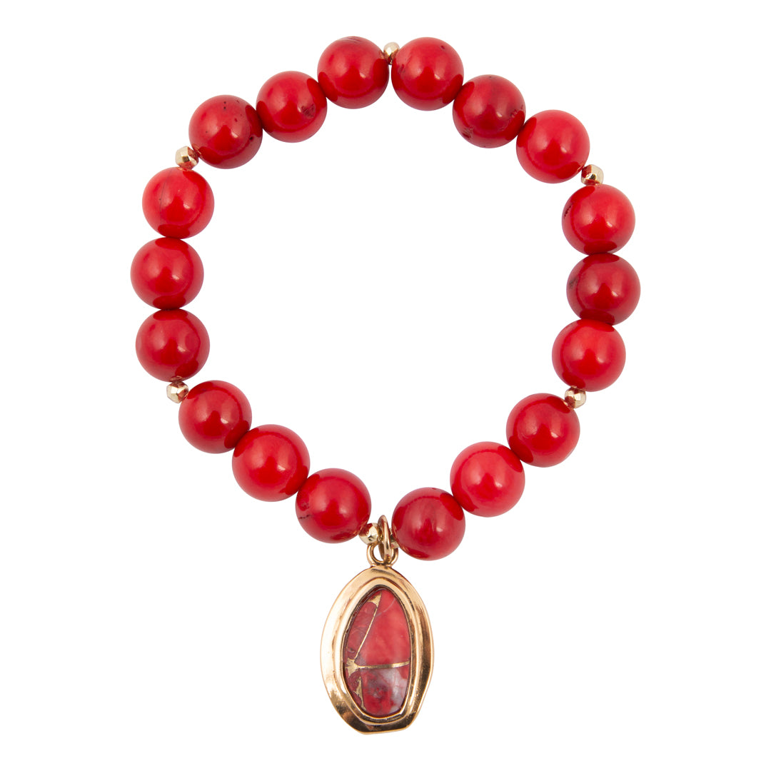 Red beaded bracelet with a gold pendant on a white background
