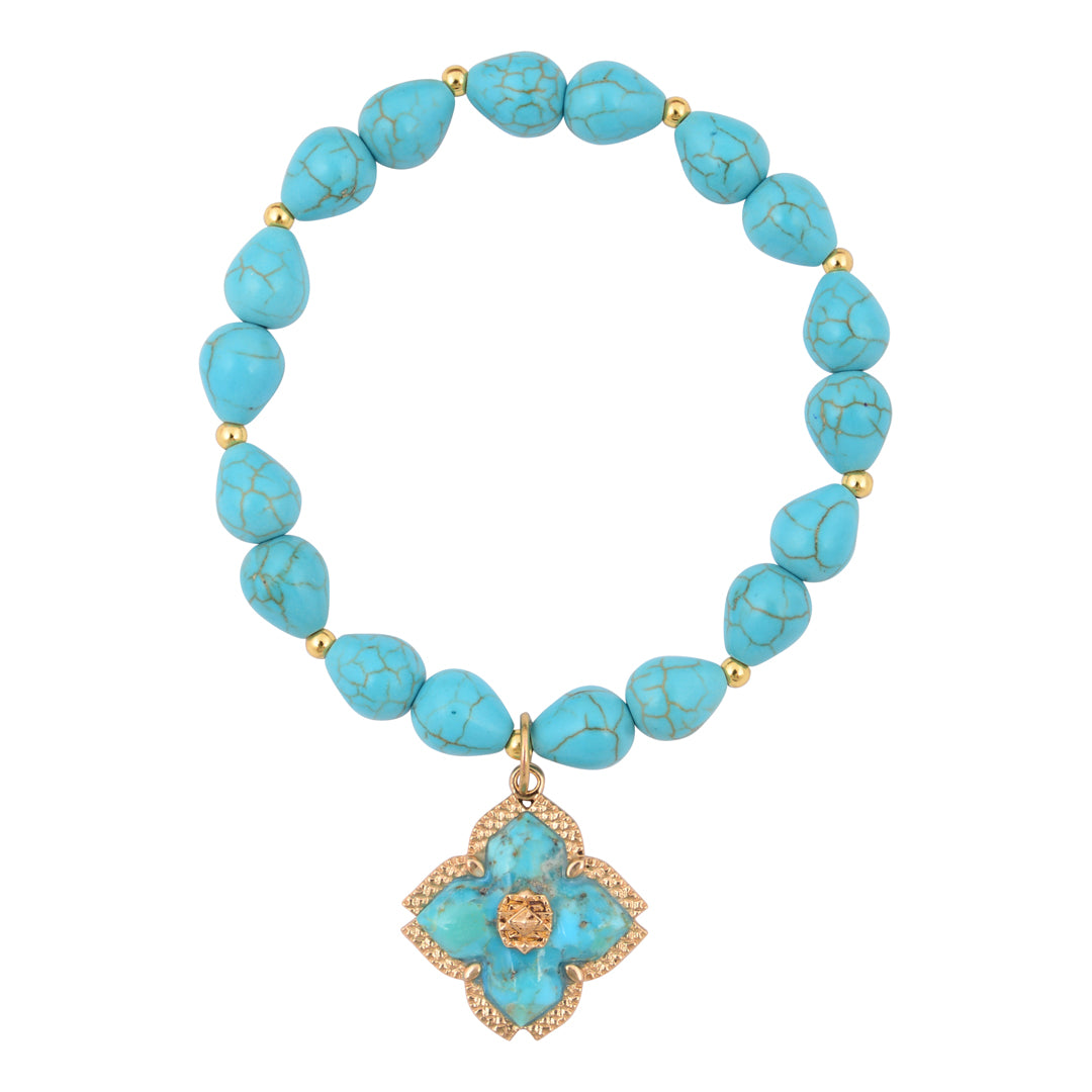 Turquoise beaded necklace with a gold flower pendant on a white background