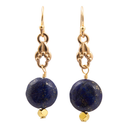Pair of earrings with blue beads and gold accents on a white background