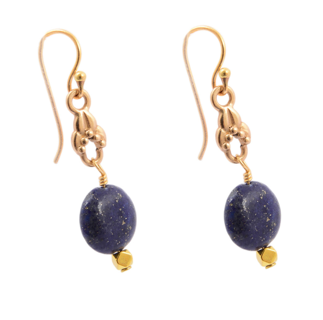 Gold earrings with blue stones on a white background