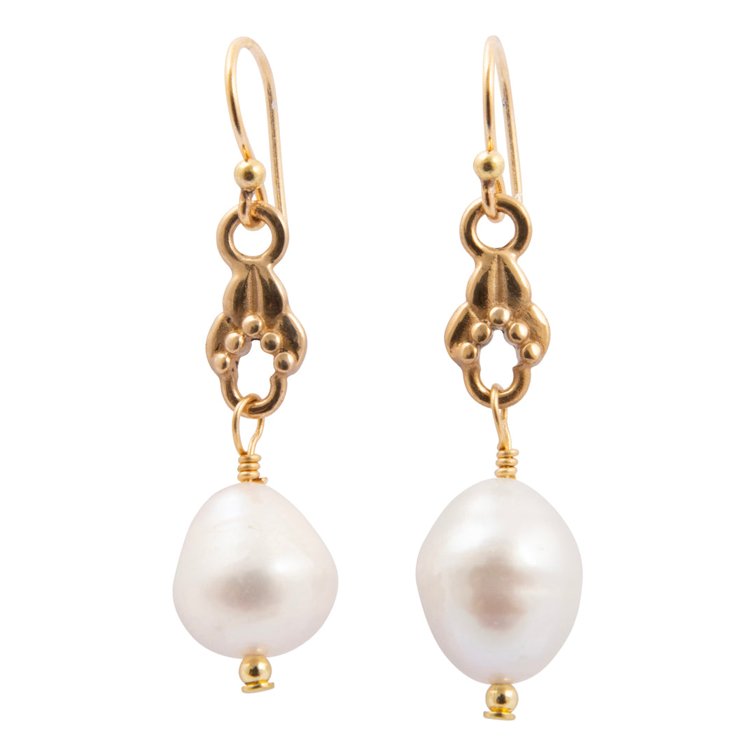 Pair of pearl earrings with gold hooks on a white background