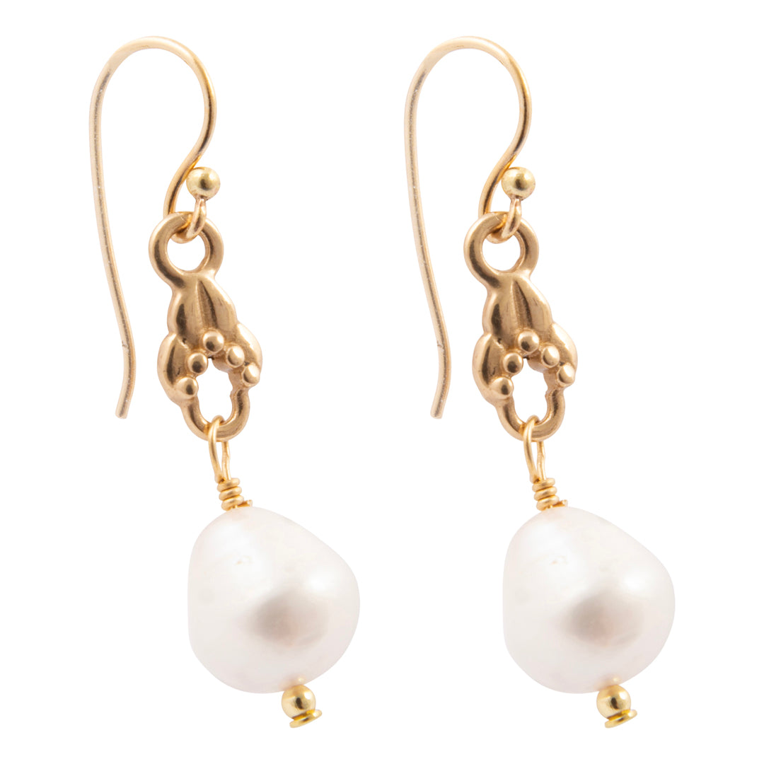 Gold earrings with white pearls on a white background