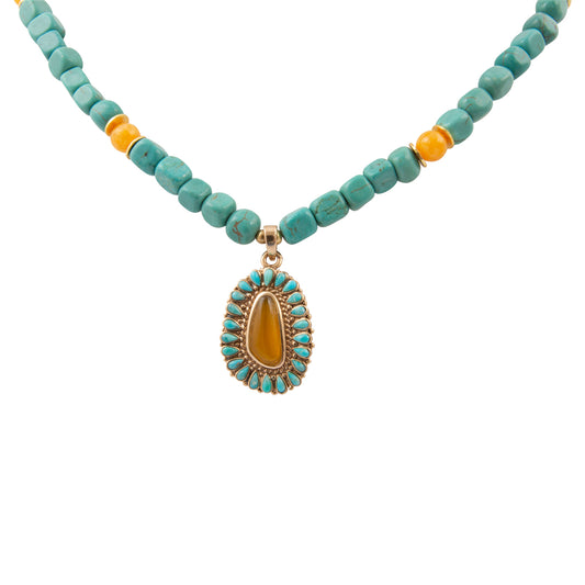 Necklace with turquoise beads and a yellow pendant on a white background