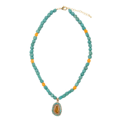 Necklace with turquoise beads and a decorative pendant on a white background