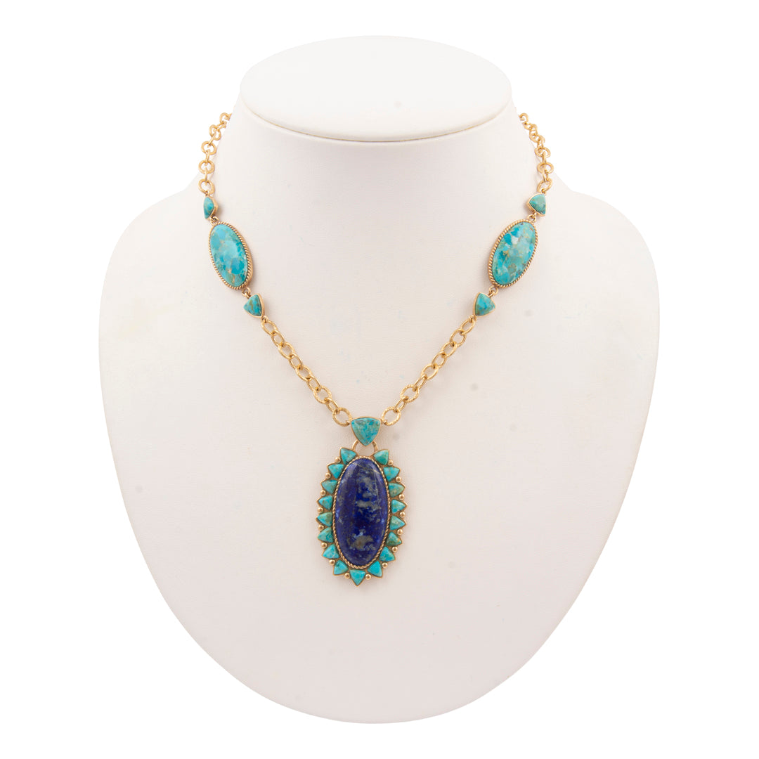 Necklace with blue and green stones on a white stand