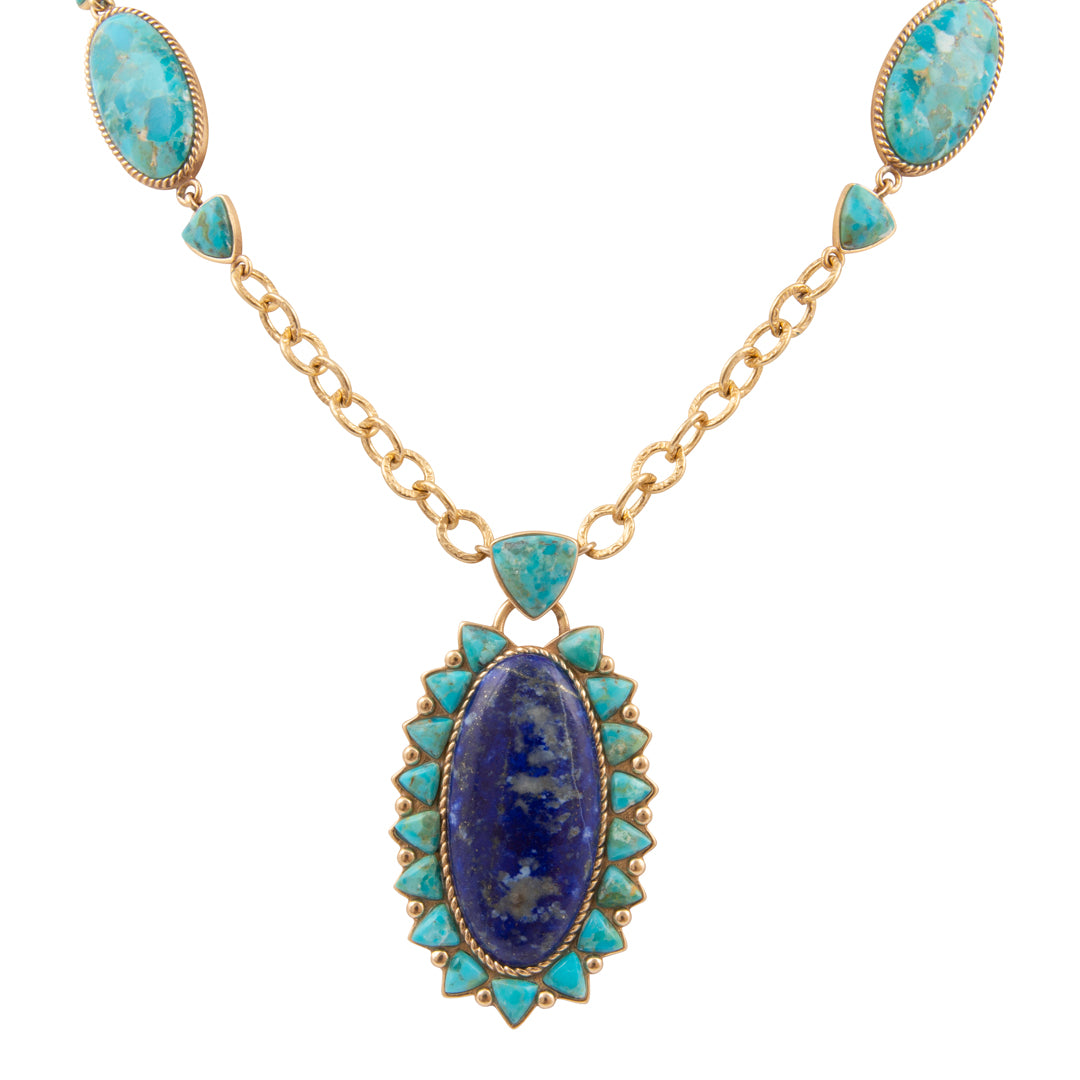 Necklace with blue stone pendant and gold chain on a white background