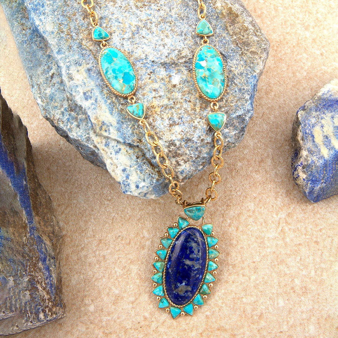 Necklace with turquoise and blue stones on a stone surface
