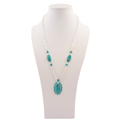 Turquoise necklace on a white mannequin bust against a white background