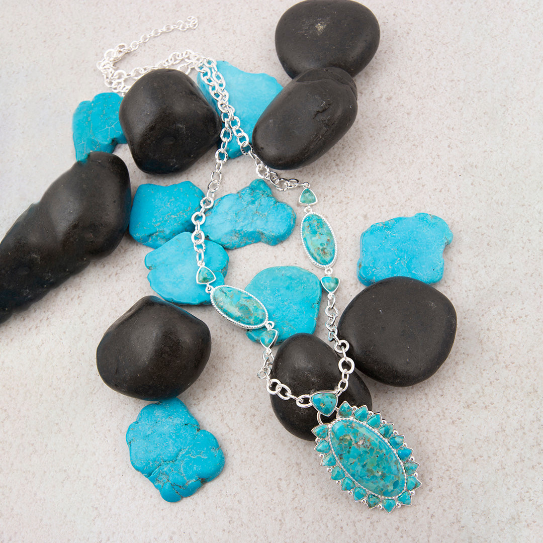 Turquoise necklace with silver pendant on black stones