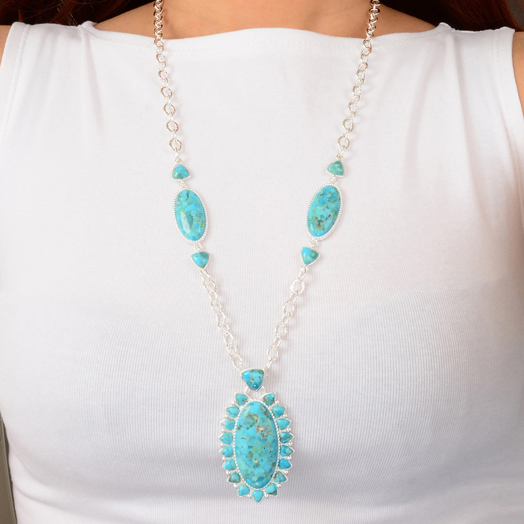 Turquoise necklace with silver chain on a white background