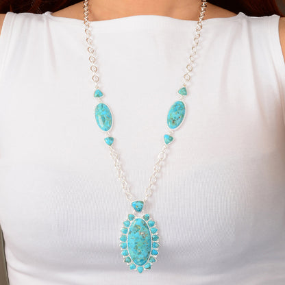 Turquoise necklace with silver chain on a white background