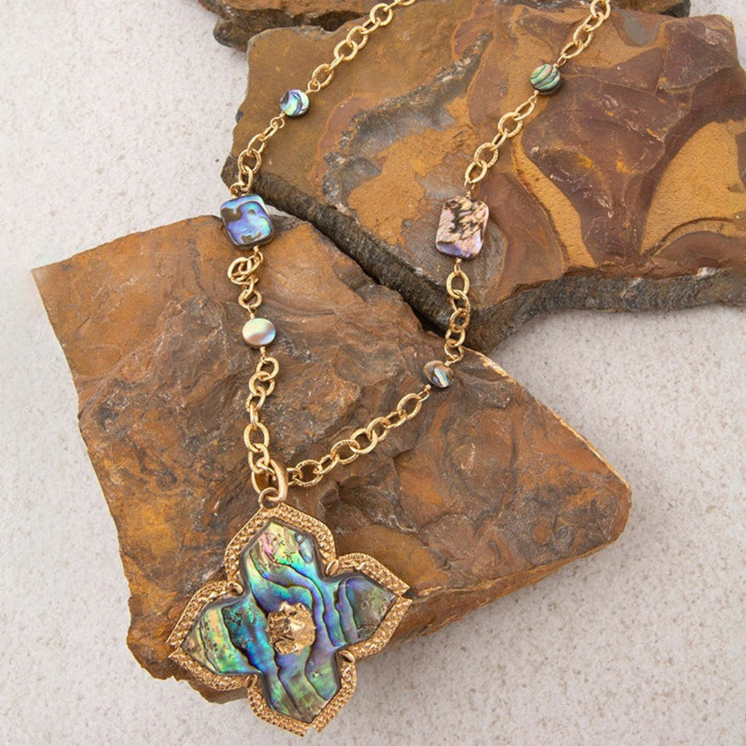 Necklace with a decorative pendant on a textured surface