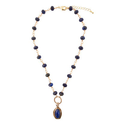 Necklace with blue beads and a gold pendant on a white background