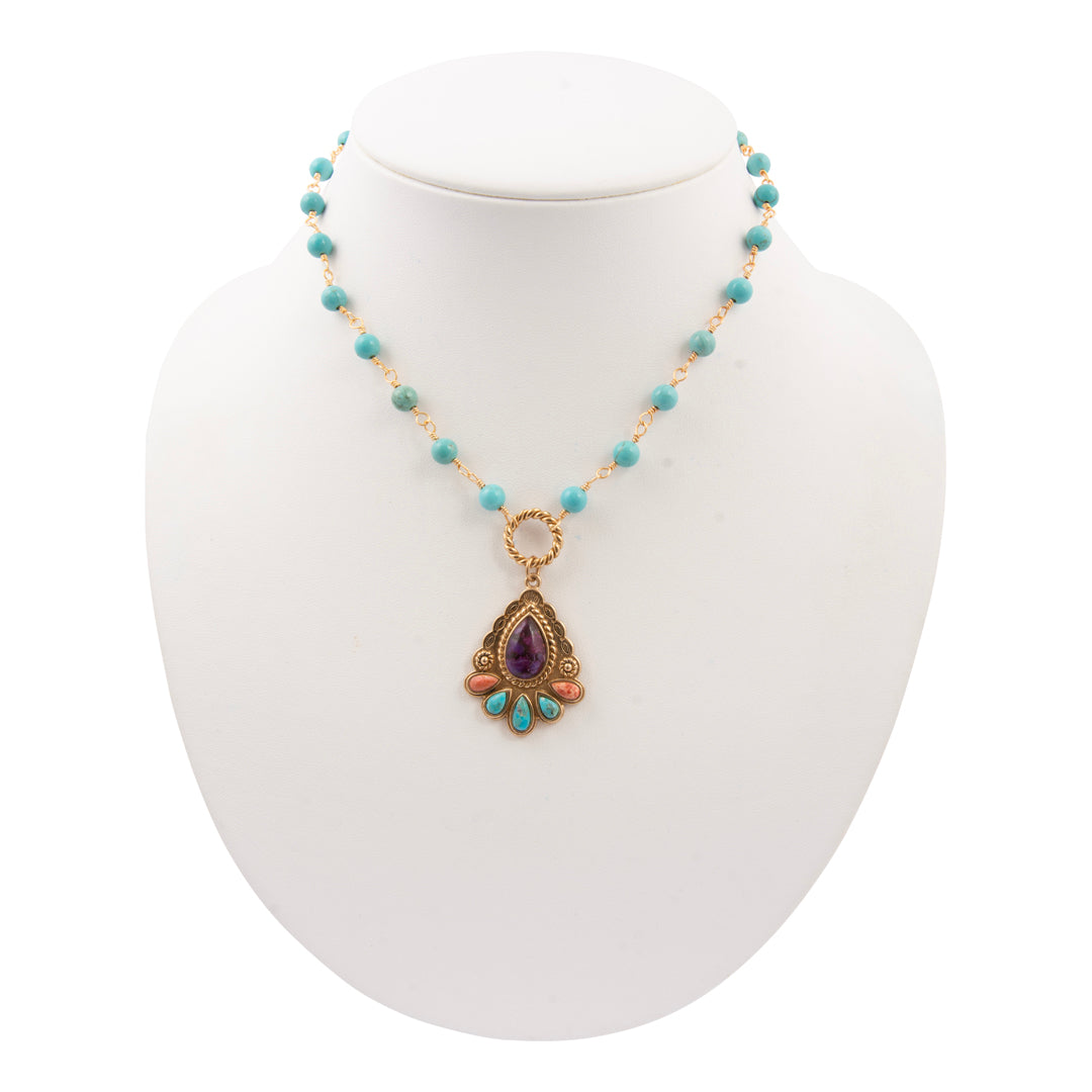 Necklace with a pendant on a mannequin bust against a white background