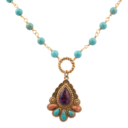 Necklace with turquoise beads and a decorative pendant on a white background