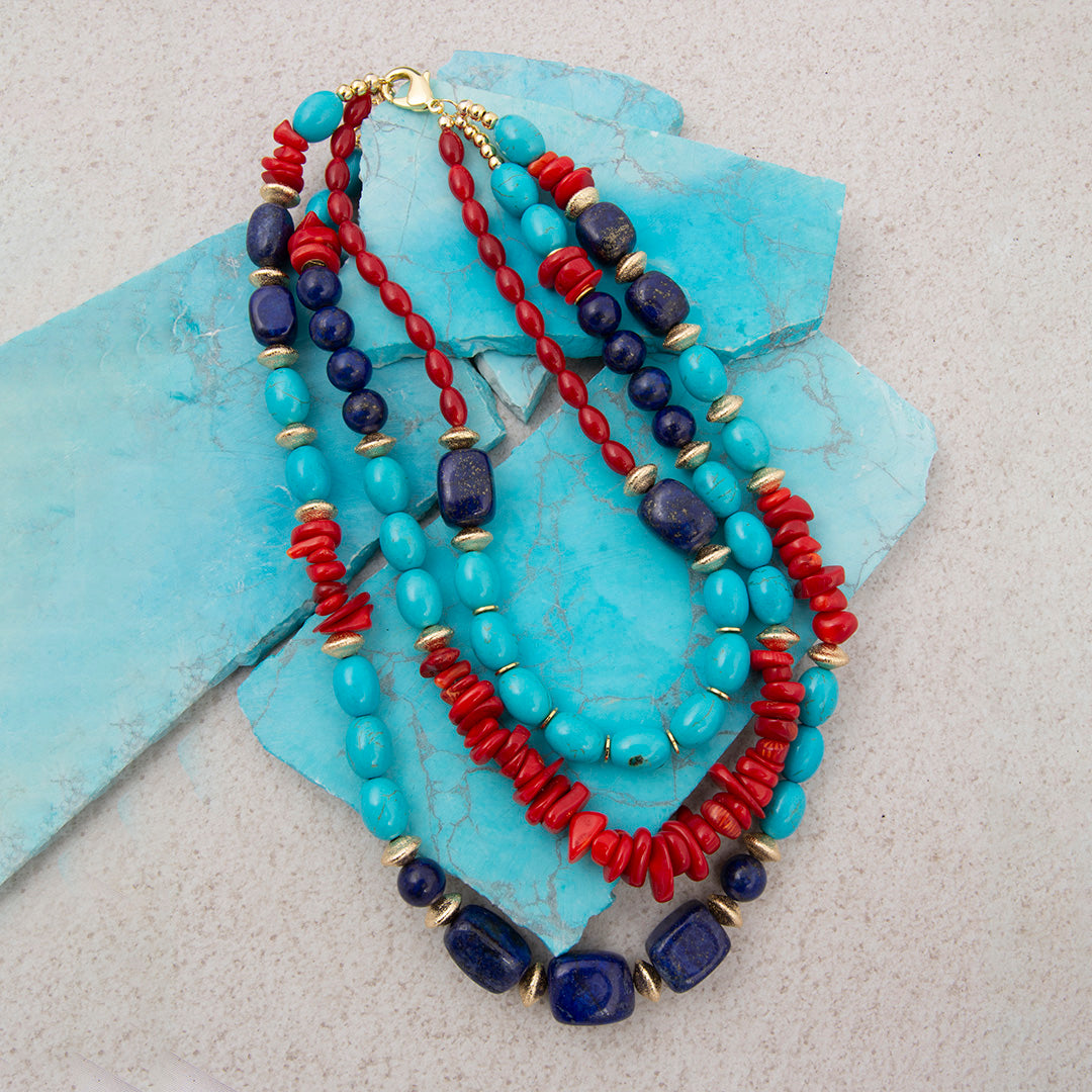 Necklace with blue and red beads on a turquoise stone background