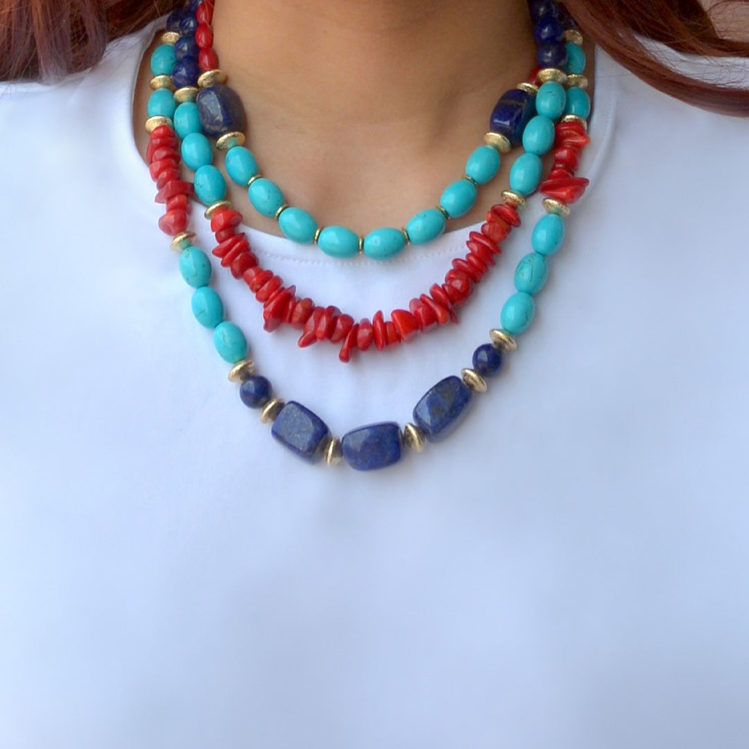 Necklace with turquoise, red, and blue beads on a white background