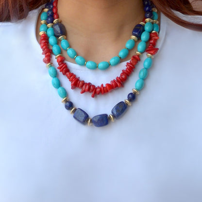 Necklace with turquoise, red, and blue beads on a white background