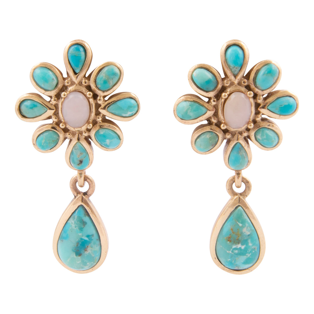 Pair of earrings with turquoise stones and gold accents on a white background