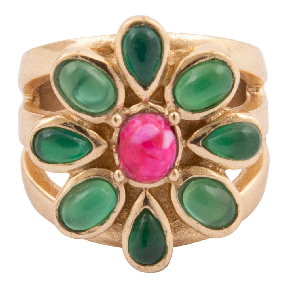 Gold ring with green gemstones and a pink central stone on a white background