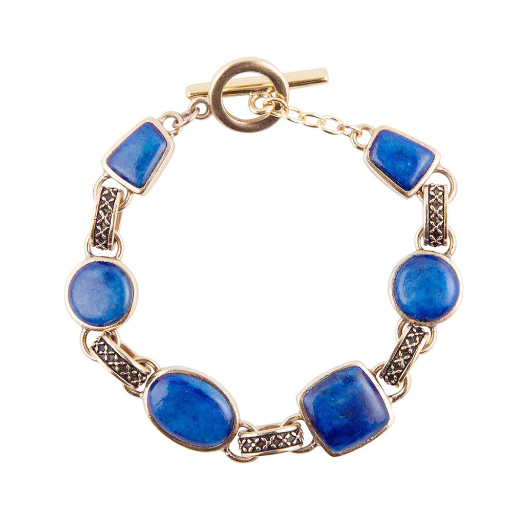 A gold-tone link bracelet featuring alternating oval and rectangular blue stone beads, with textured dark metal connectors and a toggle clasp, shown on a plain white background.