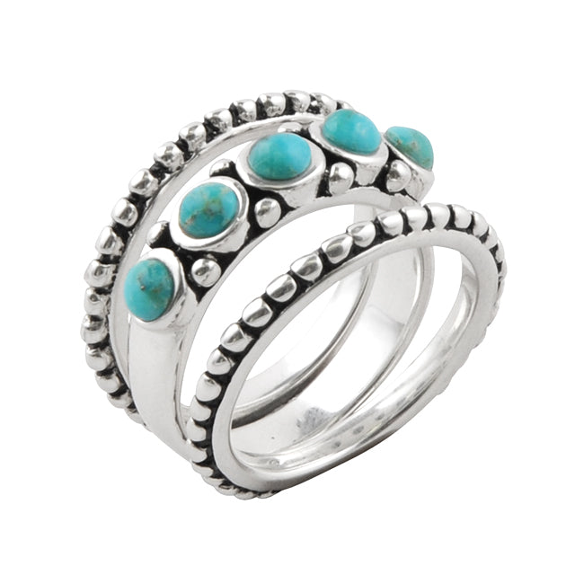 Silver ring with turquoise stones on a white background