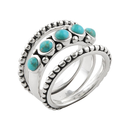 Silver ring with turquoise stones on a white background