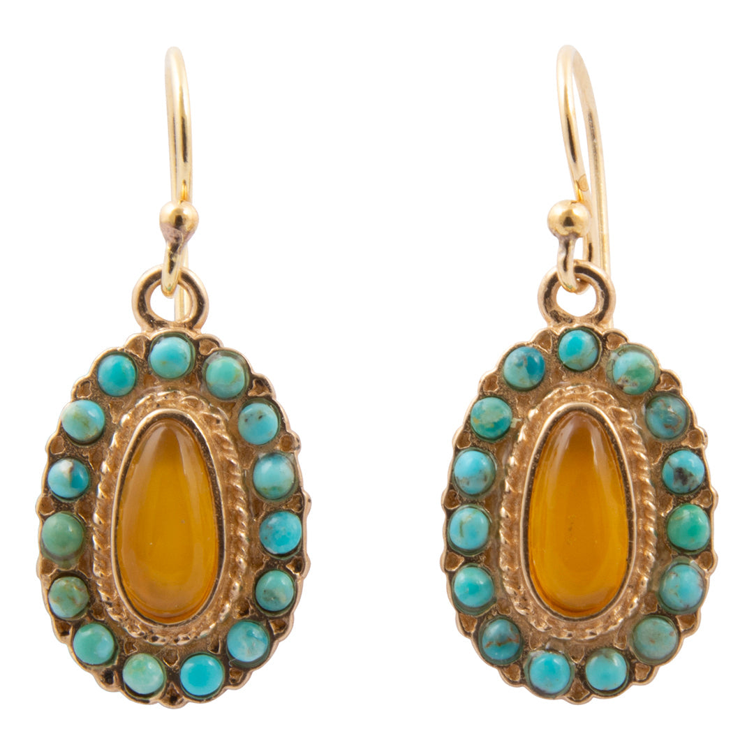 Pair of earrings with gold frame, amber center, and turquoise stones on a white background