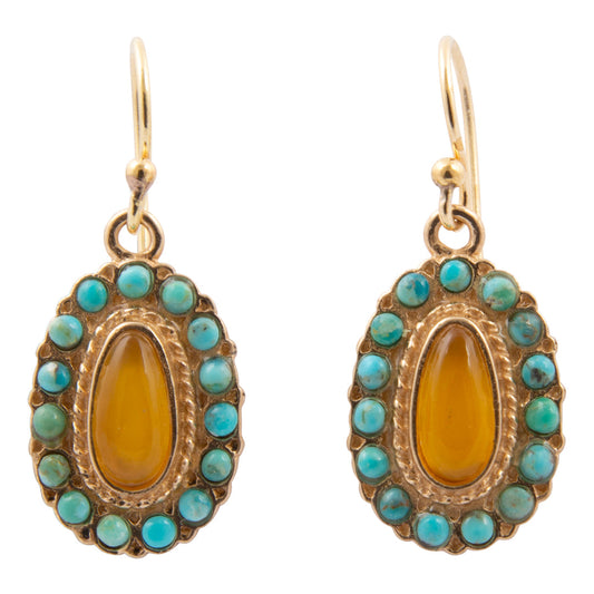 Pair of earrings with gold frame, amber center, and turquoise stones on a white background