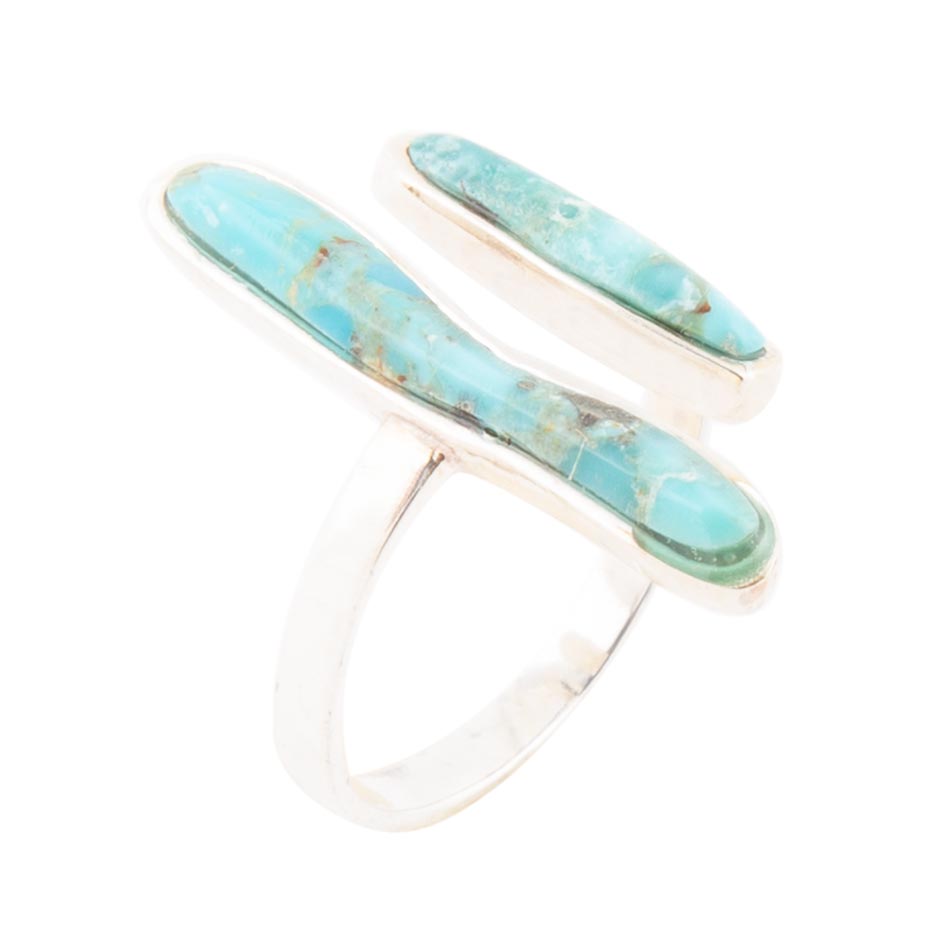 Turquoise stone ring with silver band on a white background