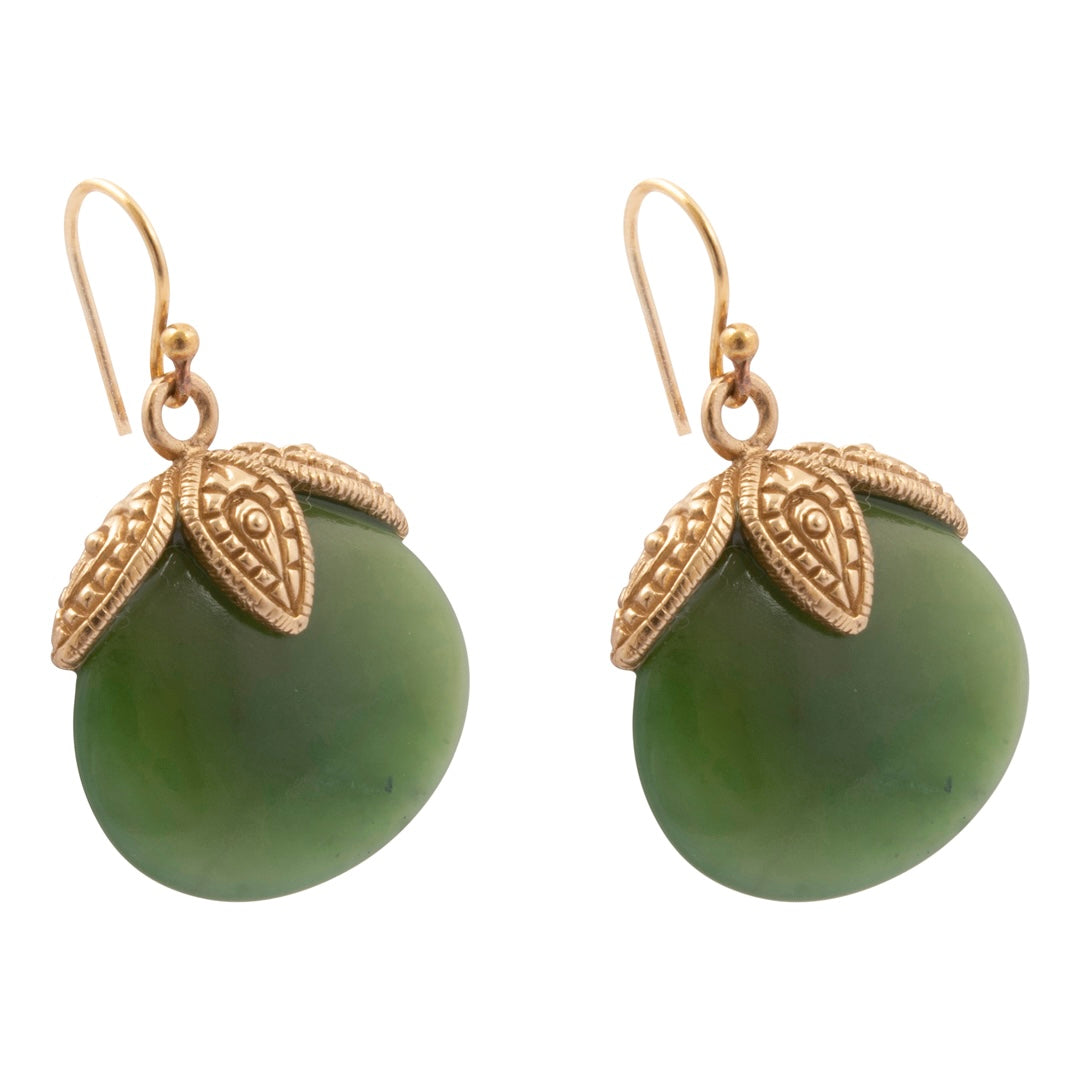 A pair of gold and green drop earrings featuring smooth oval green stone pendants topped with ornate textured gold leaf-like caps, suspended from gold fishhook wires, shown on a plain white background.