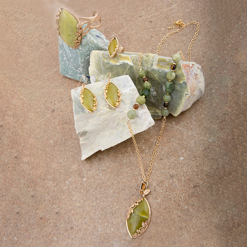 Jewelry set with necklace and earrings on a stone surface
