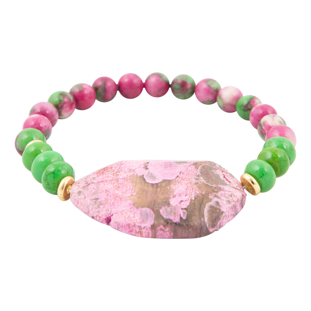 Bracelet with green and pink beads featuring a large pink stone on a white background